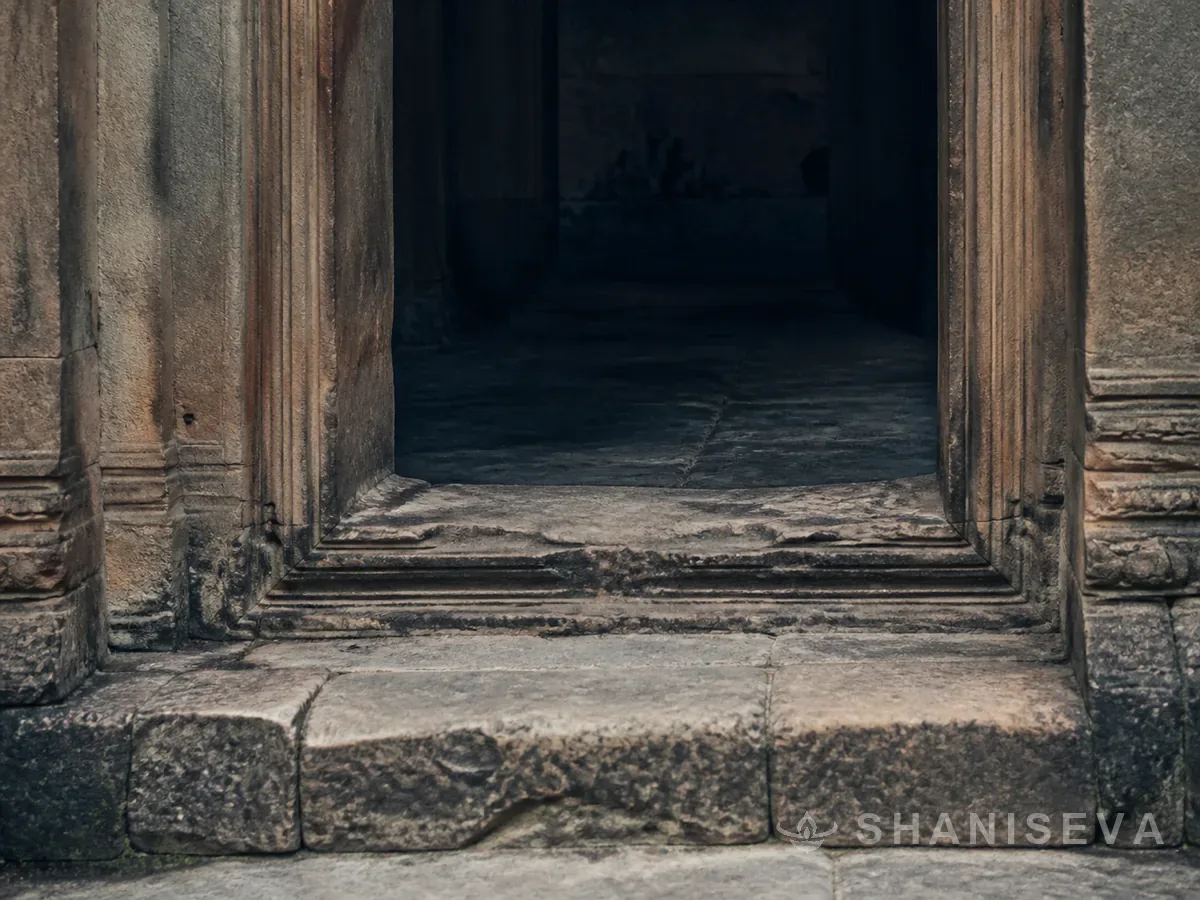 A worn stone threshold with shadow beyond